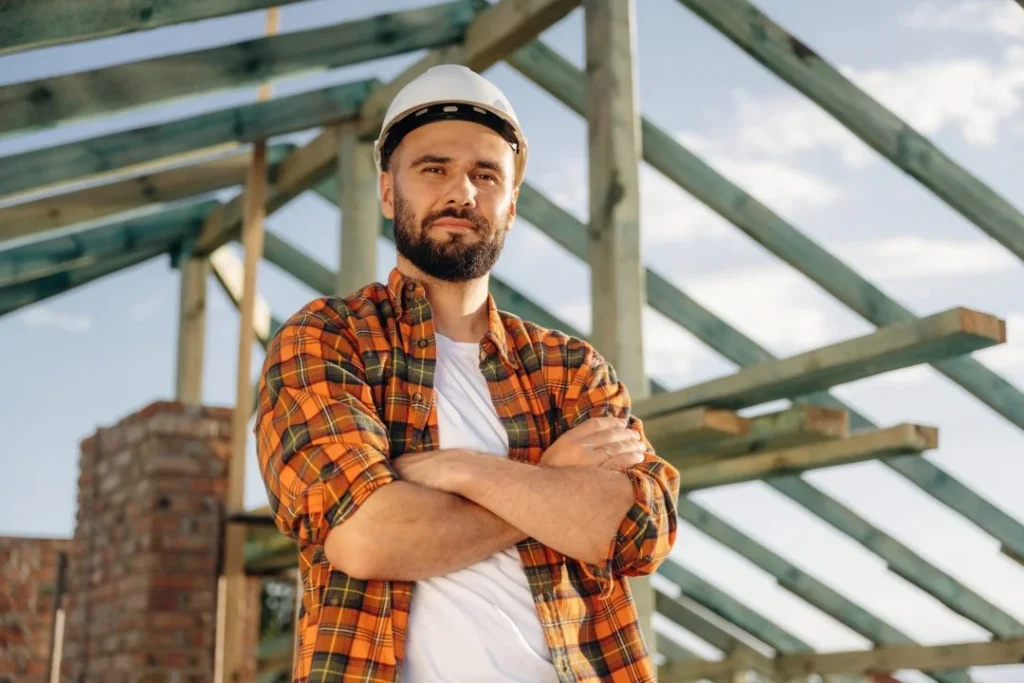 Construction worker standing on front of a site.