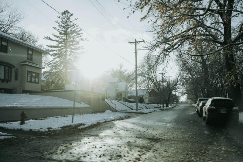 Frosty roads lined with residential houses bathed in bright winter sunlight in Dixon, IL.