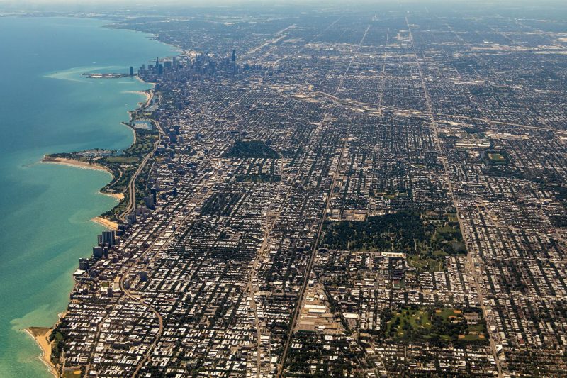 Aerial view of Chicago showcasing the skyline, Lake Michigan, and surrounding urban landscape.