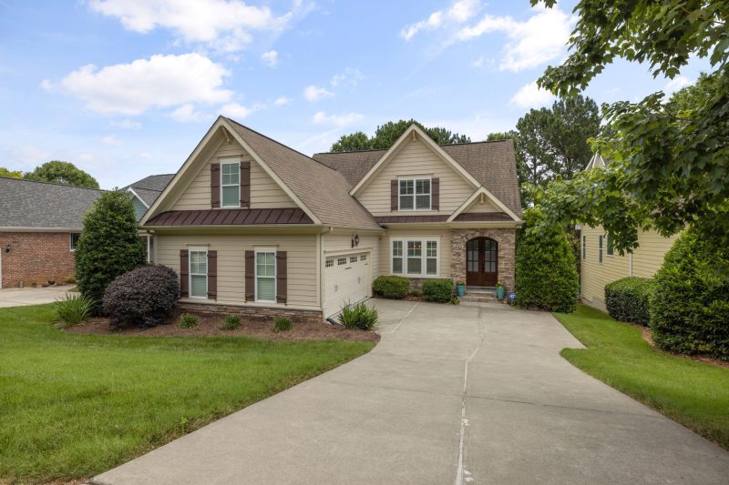 Beautiful suburban family house with a manicured lawn and neat driveway, showcasing a welcoming atmosphere.